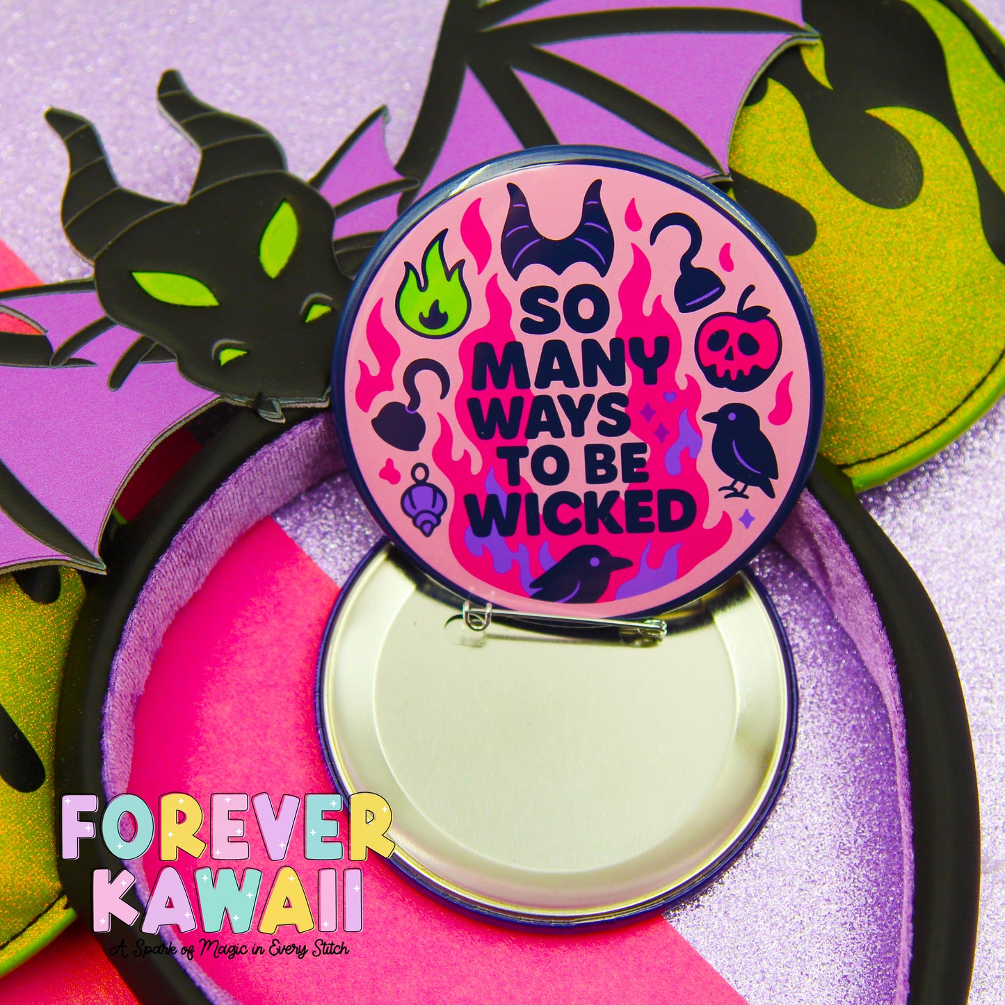 A pin with a dragon design and various symbols, including a fire, a skull, and a bird, along with the text "So Many Ways to be Wicked" and "FREVER KAWAI" printed on it.