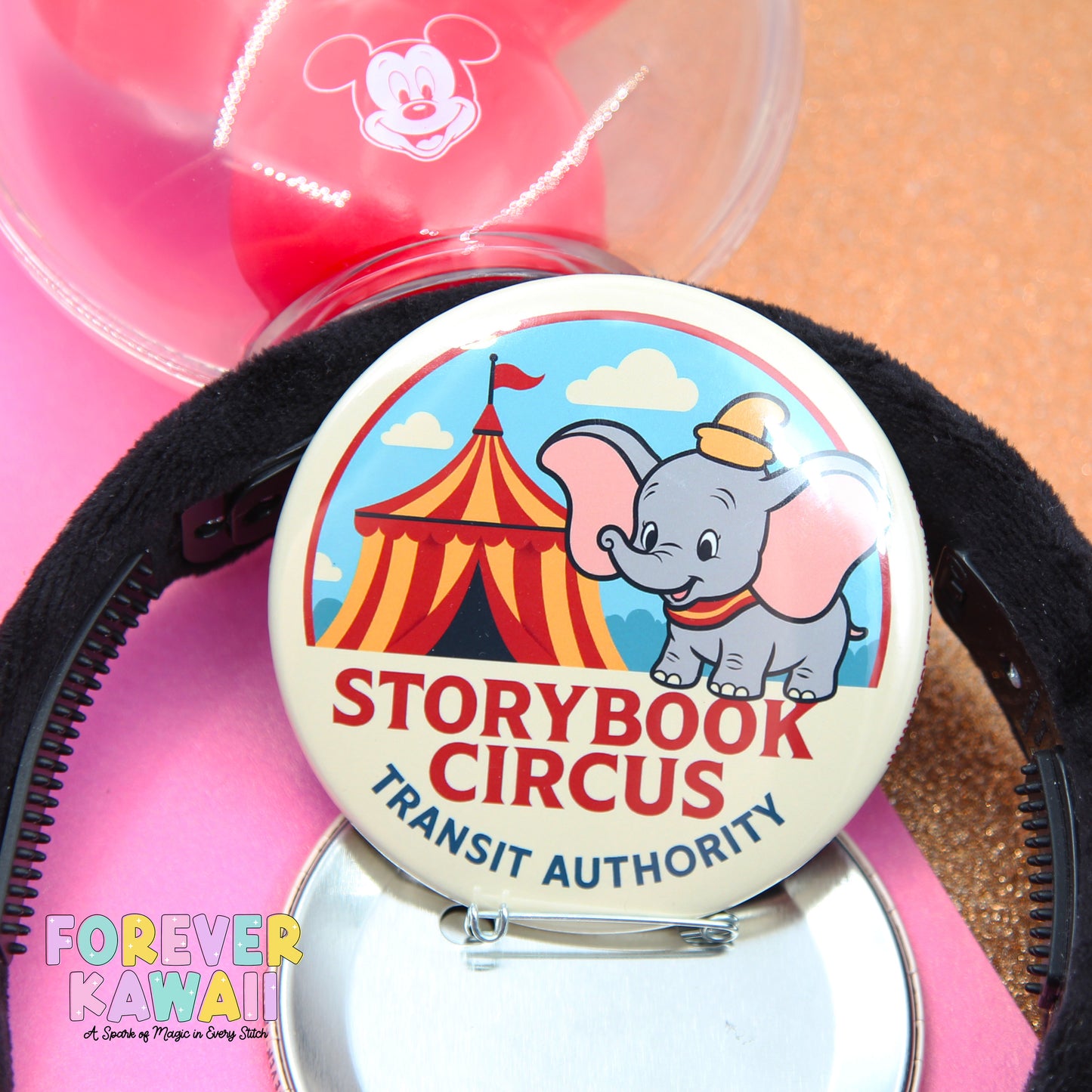 a round pin with a cartoon elephant and a circus tent, along with the text "STORYBOOK CIRCUS" and "TRANSIT AUTHORITY".
