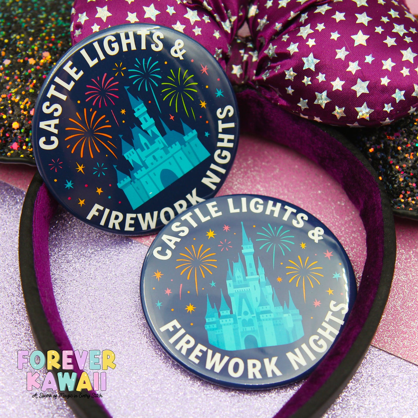 two circular badges with a castle and fireworks design, placed on a pink glittery surface.