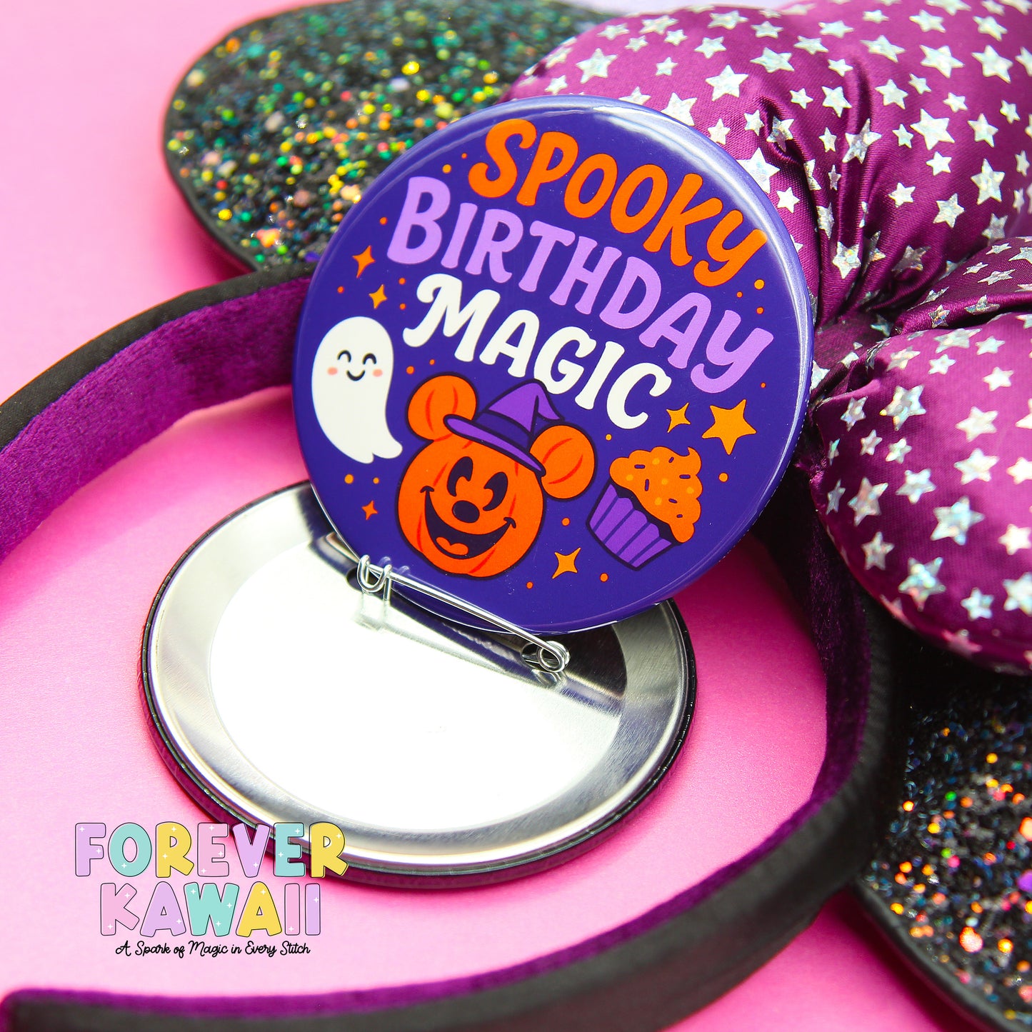 A purple bow with a spooky birthday magic badge featuring a ghost and a pumpkin, placed on a pink background.