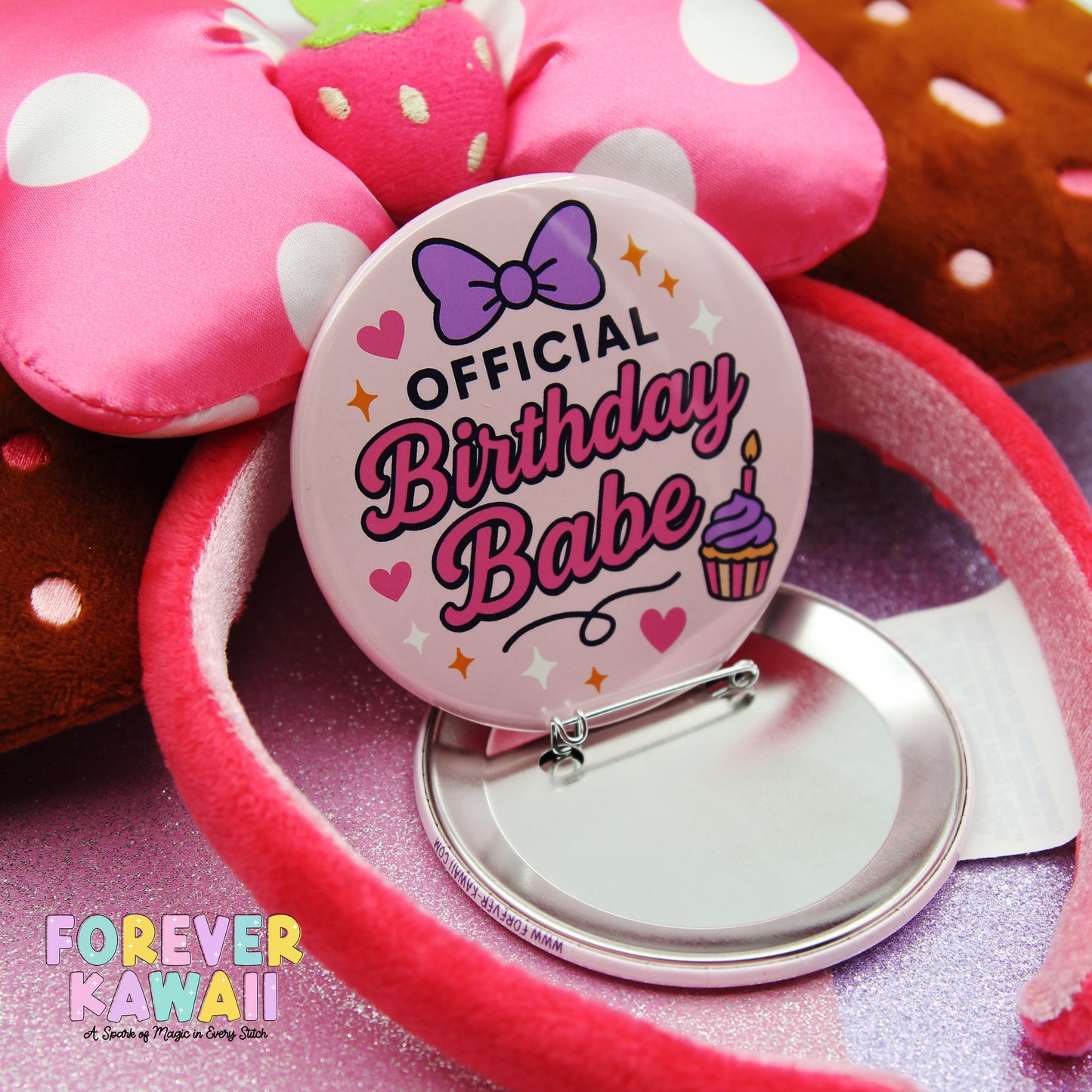 a pink polka dot headband with a round badge that says "OFFICIAL BIRTHDAY BABE" and has a cupcake and heart design. The background is pink and has a text that says "FREVER KAWAI" and "A scene of magic in every stitch".