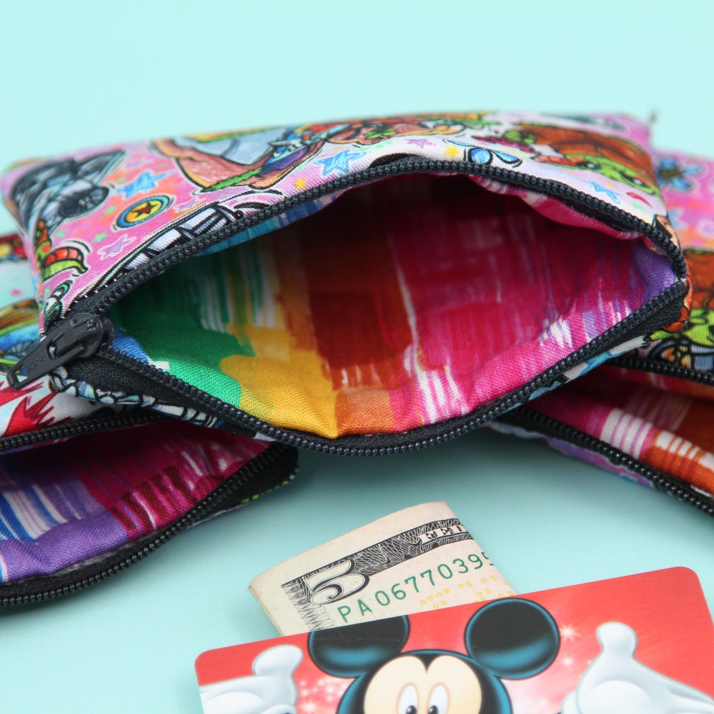 Handmade Baby Alien zipper pouch in whimsical theme park design, perfect for holding cash, cards, and passes