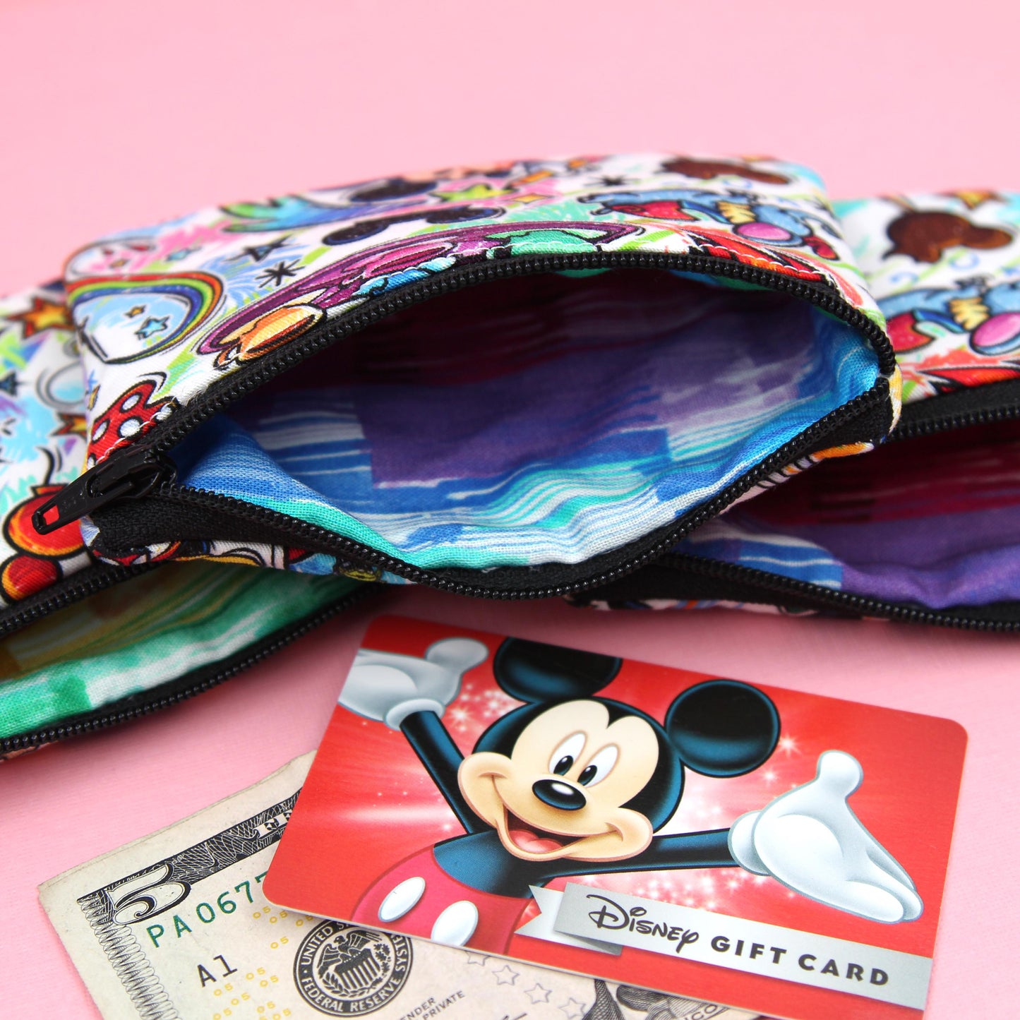 Handmade zipper pouch featuring an art-inspired design with colorful characters and paint details, perfect for holding coins, cards, and other small essentials. Ideal for theme park visits or as a creative gift for art lovers.