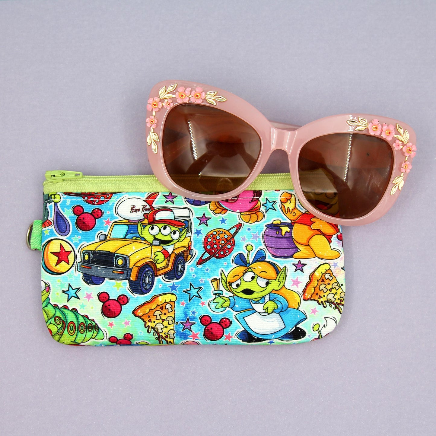 Handmade zipper pouch featuring a Baby Grogu-inspired character enjoying theme park rides, perfect for protecting eyeglasses, sunglasses, makeup essentials, or small travel items.
