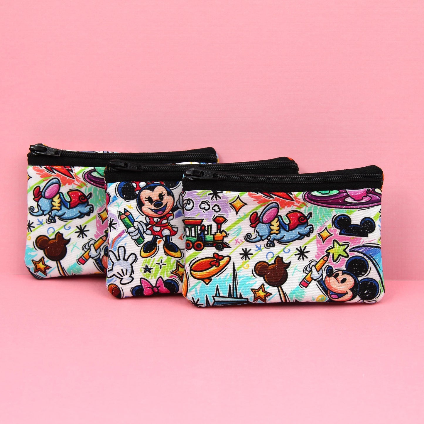 Handmade zipper pouch featuring an art-inspired design with colorful characters and paint details, perfect for holding coins, cards, and other small essentials. Ideal for theme park visits or as a creative gift for art lovers.