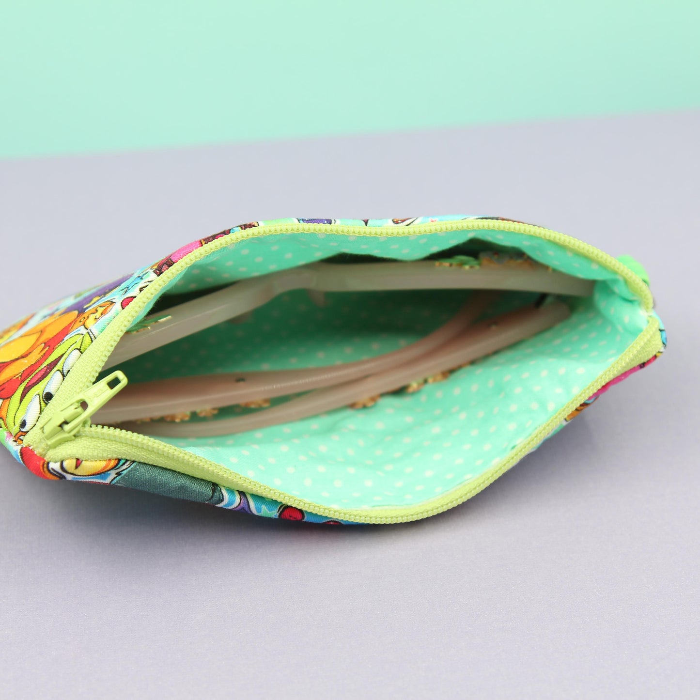 Handmade zipper pouch featuring a Baby Grogu-inspired character enjoying theme park rides, perfect for protecting eyeglasses, sunglasses, makeup essentials, or small travel items.