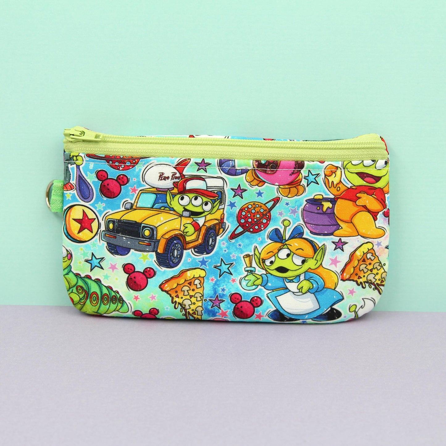 Handmade zipper pouch featuring a Baby Grogu-inspired character enjoying theme park rides, perfect for protecting eyeglasses, sunglasses, makeup essentials, or small travel items.