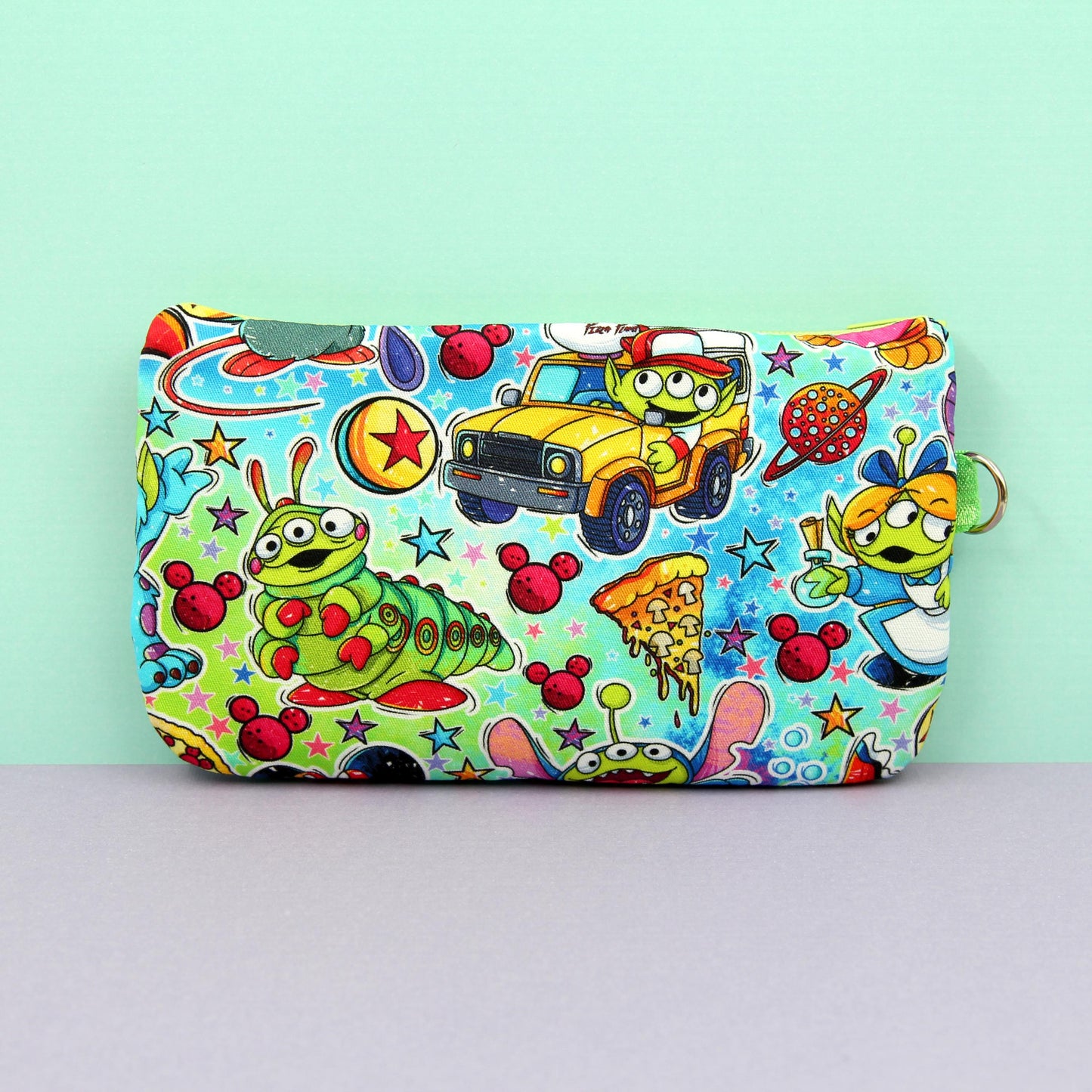 Handmade zipper pouch featuring a Baby Grogu-inspired character enjoying theme park rides, perfect for protecting eyeglasses, sunglasses, makeup essentials, or small travel items.