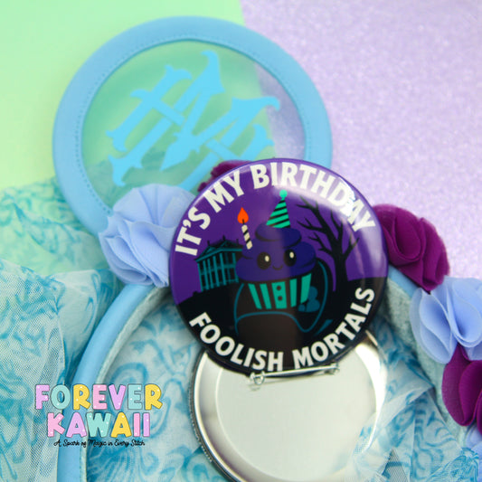 a birthday-themed item with a purple and black design, surrounded by various other items such as a blue headband, a mirror, and some flowers.