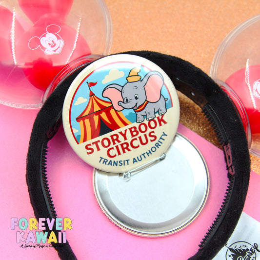 a pink background with a black headband, a round pin, and a clear container with a Mickey Mouse logo.