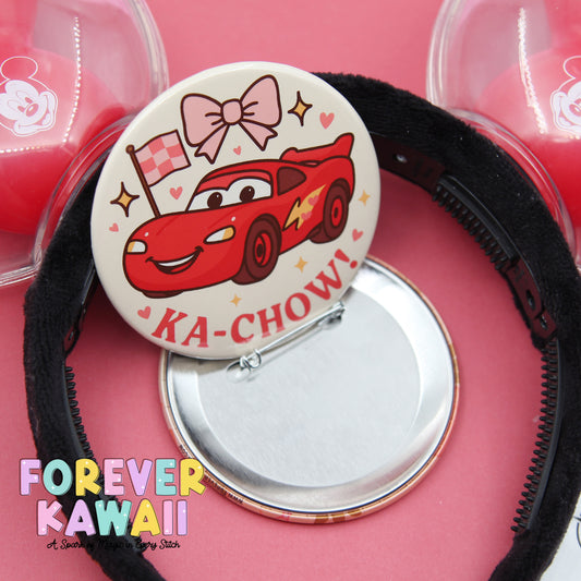 a round pin with a cartoon car design, a black hairband, and a silver pin with a mirror. The pin with the car design has a bow and the word "KA-CHOW" written on it. The image also includes text that says "FREVER KAWAWAII" and "A Sparkling Magic of Every Stitch".