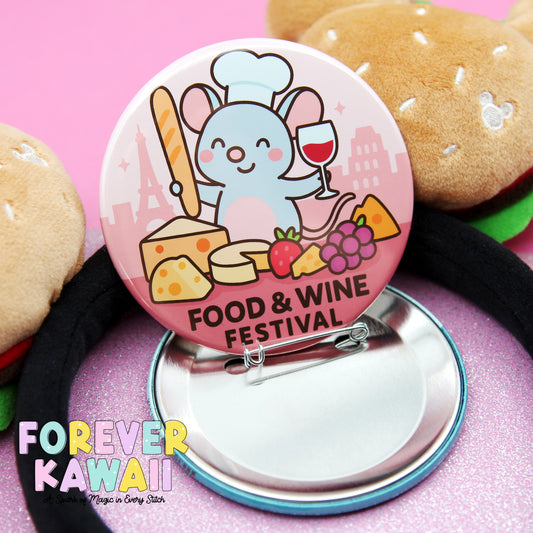 A pink button featuring a cartoon mouse holding a wine glass and surrounded by various food items, such as cheese, grapes, and a hamburger, with the text "Food & Wine Festival" and "FREVER KAWAI" below.