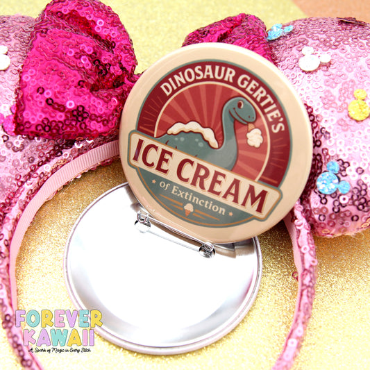 a pink sequin headband with a round badge that says "DINOSAUR GERTIE'S ICE CREAM or Extinction" on it.