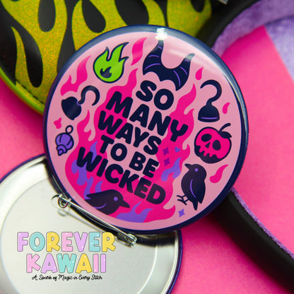 A colorful pin with the text "So many ways to be Wicked" and various whimsical illustrations, including a dragon, a witch's cauldron, and a skull.