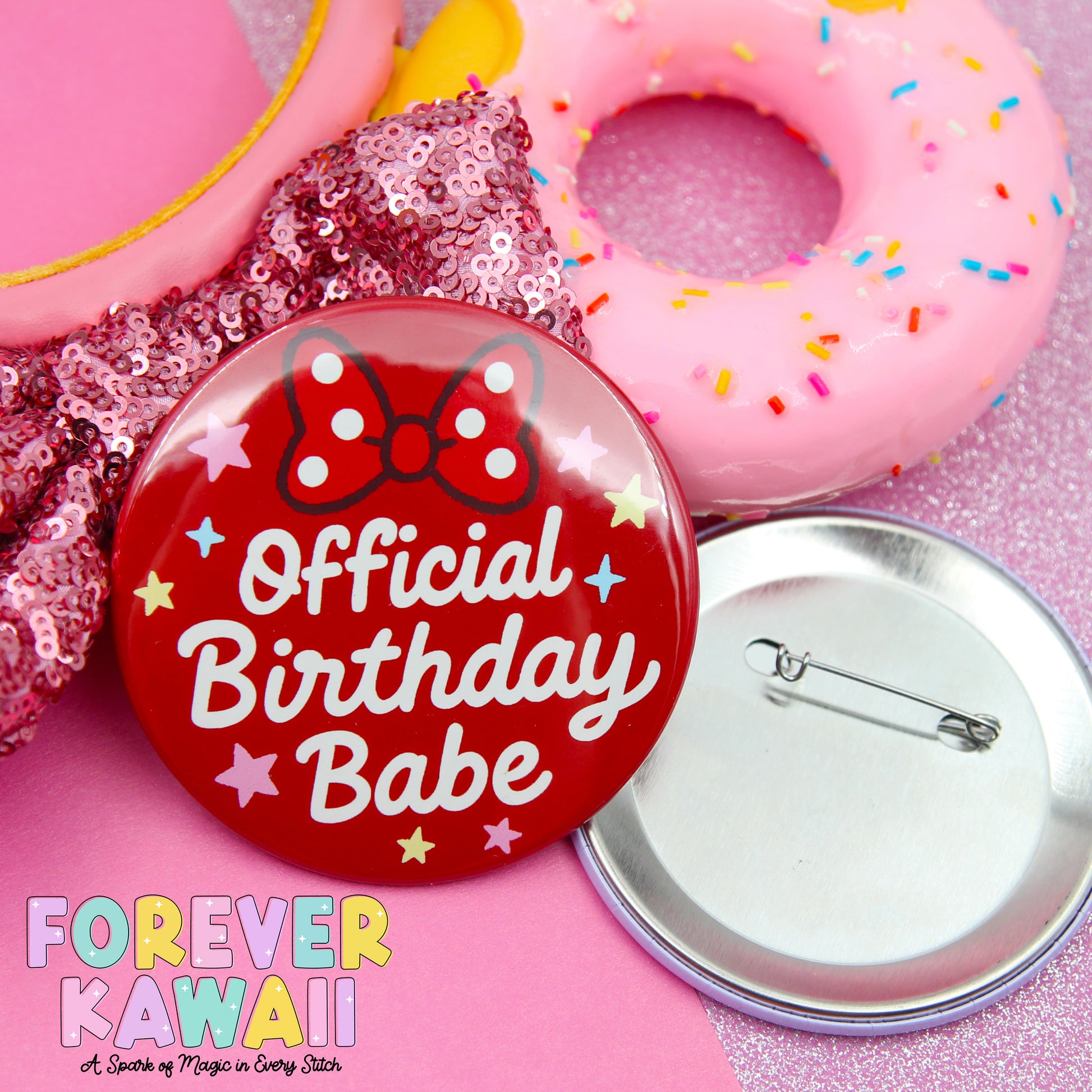 a red pin with the text "Official Birthday Babe" and a pink donut with sprinkles, along with a silver pin and a pink sequin fabric.