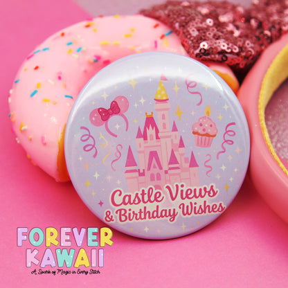 A pink donut with sprinkles, a pink cupcake, and a pink castle-themed button with the text "Castle Views & Birthday Wishes" on it, all set against a pink background.
