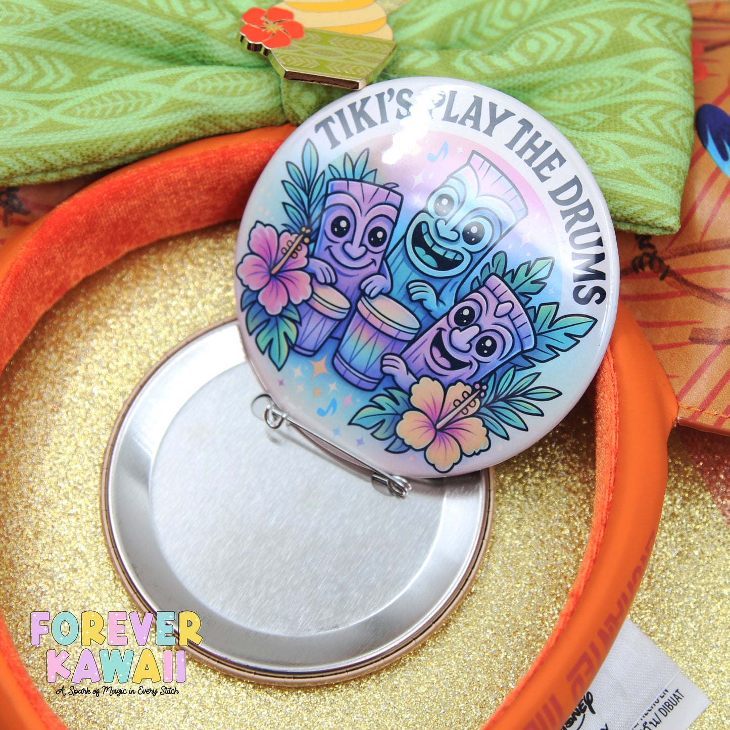 a colorful pin with a cartoon character design, placed on a surface with a glittery background.