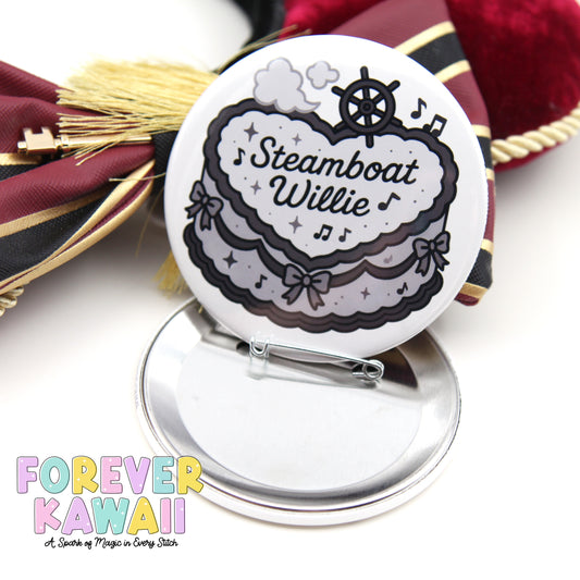 A round pin with a cartoon image of a steamboat and the name "Steamboat Willie" on it, placed on a silver stand.