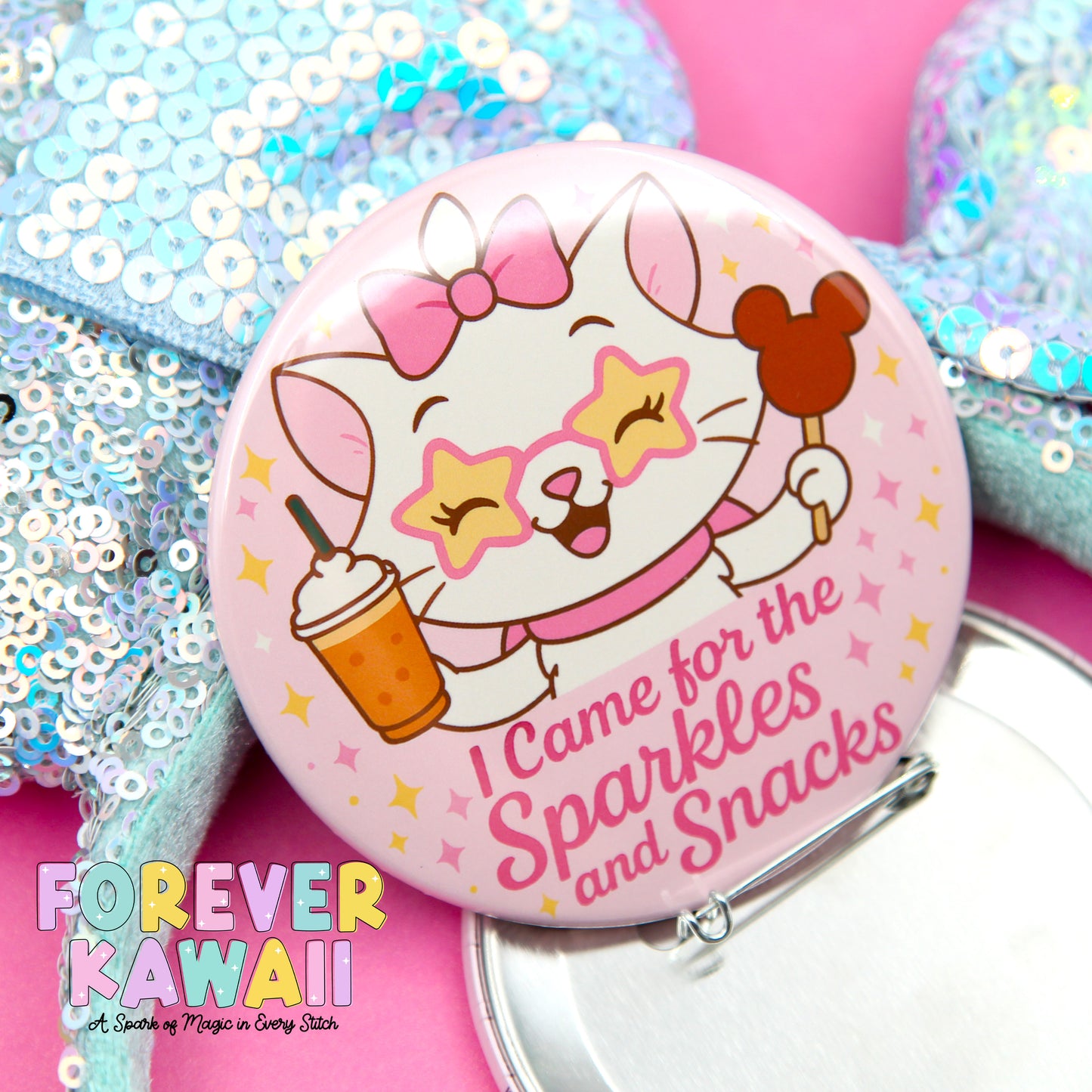 A pink button featuring a cartoon cat with a bow and sunglasses, holding a Mickey Mouse ear and a cup of ice cream, with the text "I Came for the Sparkles and Snacks" and "FREVER KAWAI" written on it.