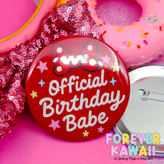 a red pin with the text "Official Birthday Babe" and colorful stars, surrounded by pink sequin decorations and a pink donut with sprinkles.