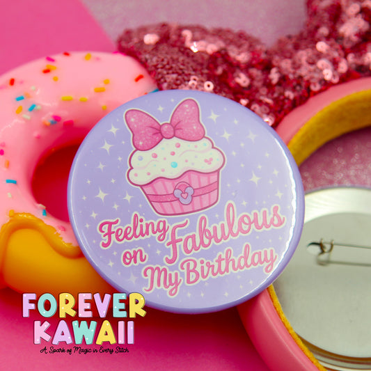 a purple button with a cupcake design and the text "Feeling on Fabulous My Birthday" on it, surrounded by pink and yellow objects such as a donut and a pink sequin headband.