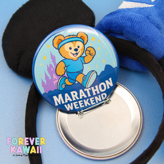 A round blue button with a cartoon bear and the text "Marathon Weekend" is shown, along with a black object and a blue object in the background.