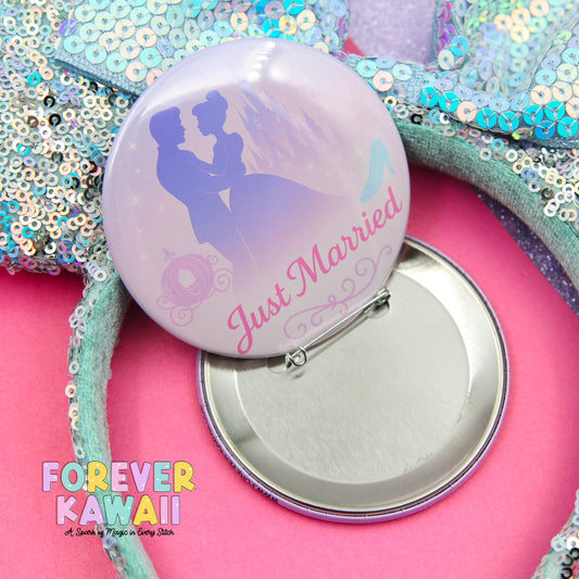 A round pin badge with a silhouette of a couple and the text "Just Married" on it, placed on a pink background.