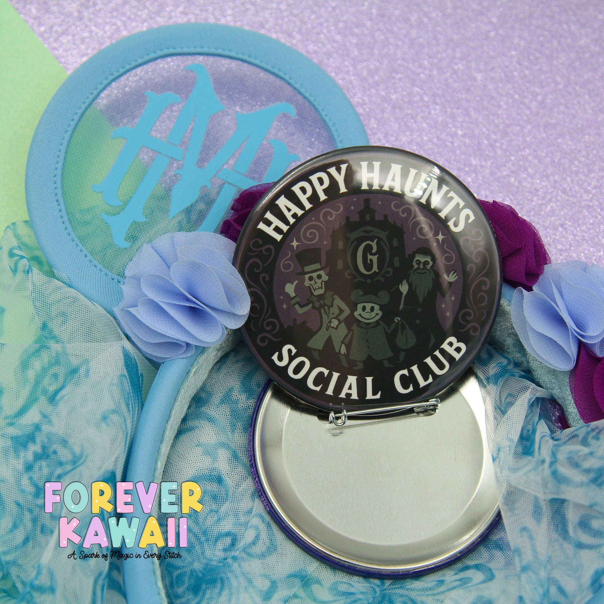 a round mirror with a black frame and a blue rim, surrounded by various decorative elements such as flowers and a light blue background.